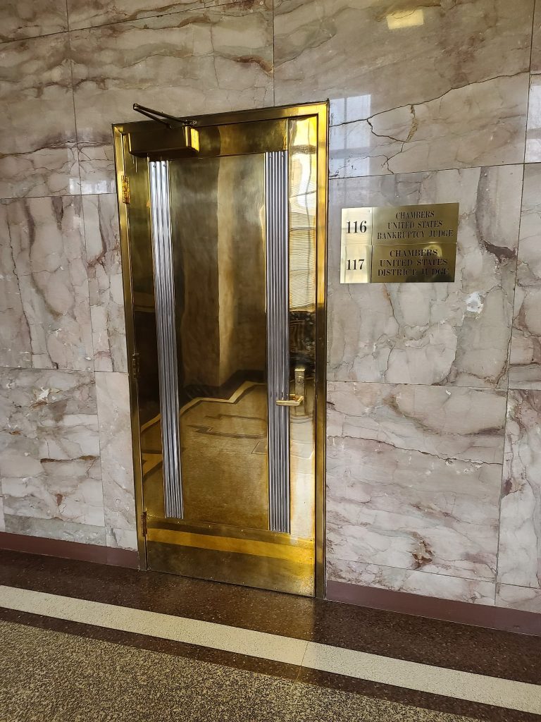 Polished bronze elevator door.